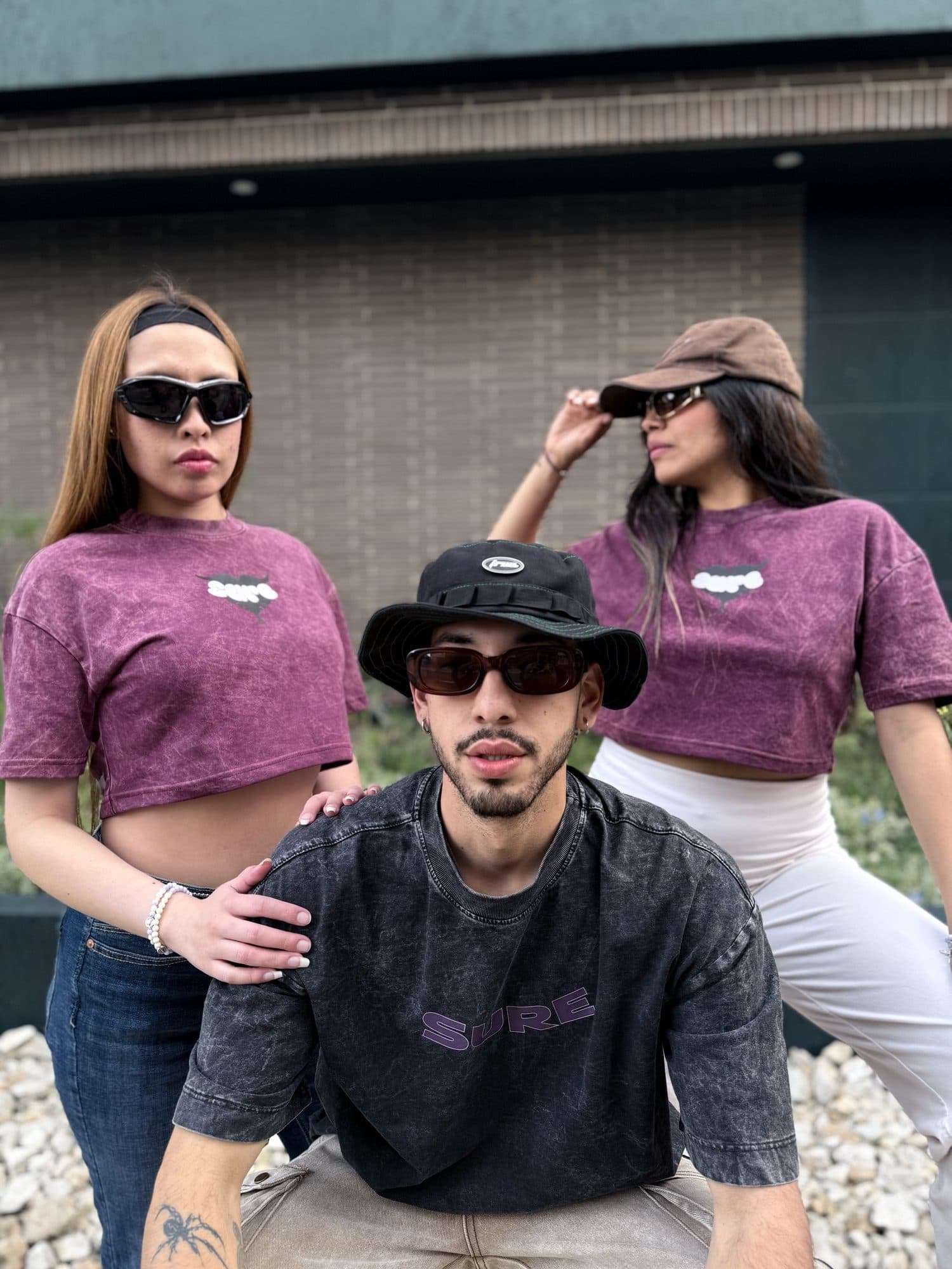 Dos modelos con el crop vino tinto y un modelo con la camiseta gris carbón Niebla x Ivy